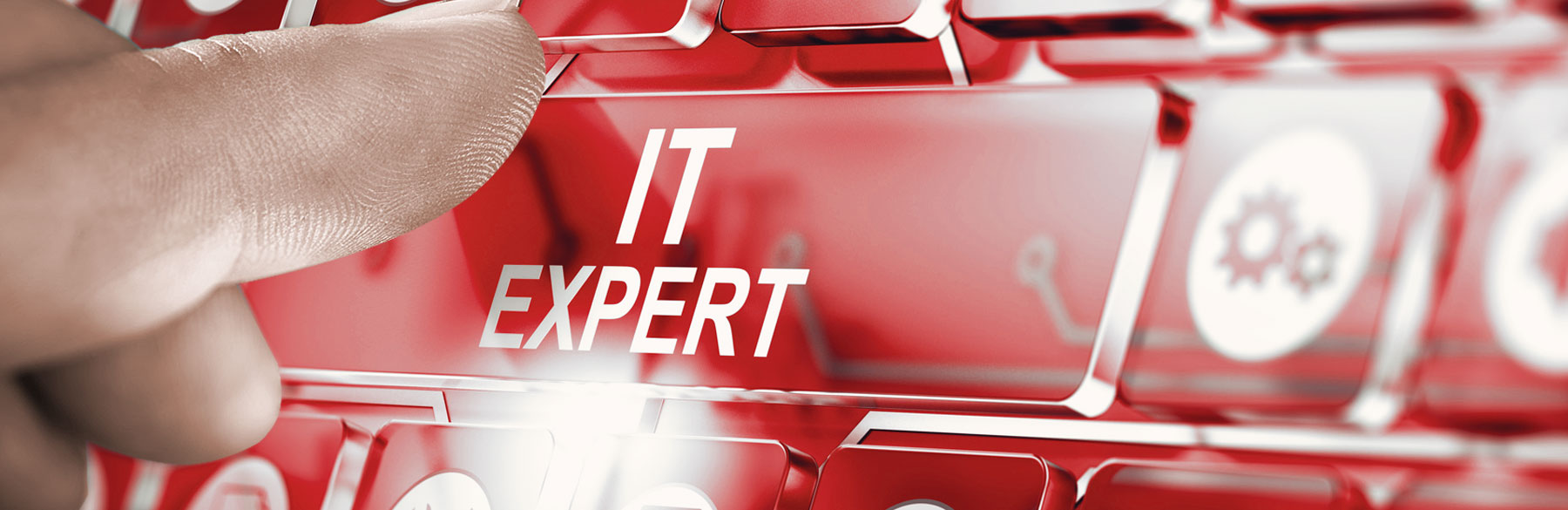 Ein Finger drückt auf eine rote Taste mit der Aufschrift IT Expert, die symbolisch für IT-Lösungen steht.